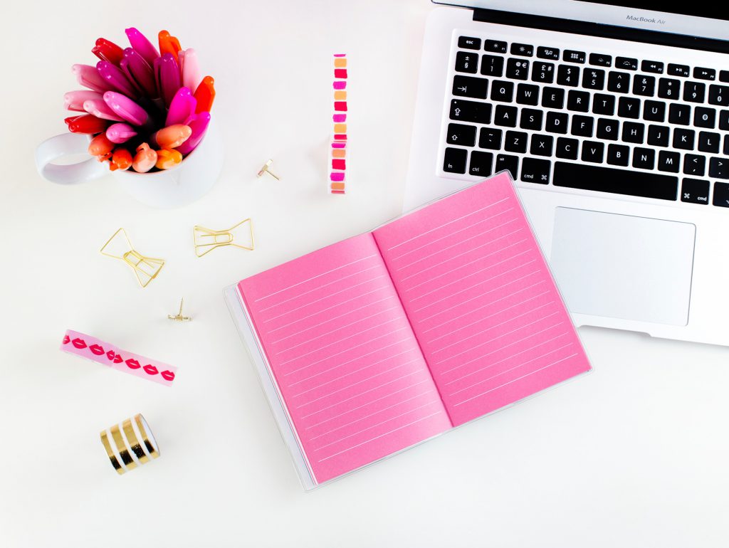 Desk with pink stationary