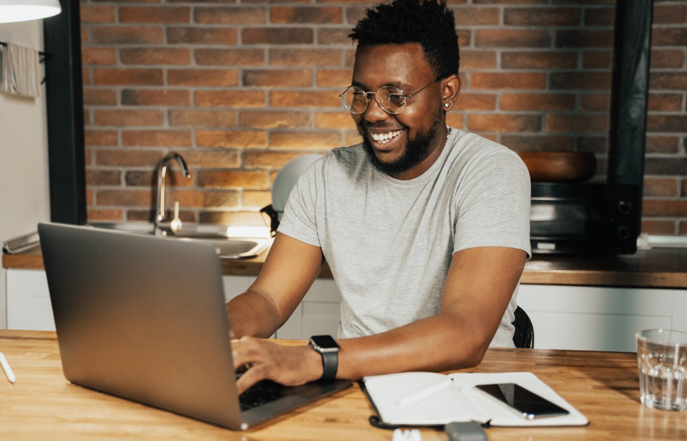 R&D tax reclaim - smiling man working at a laptop at home
