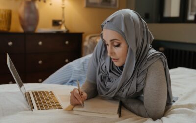 MTD 2021 - woman lying on bed with laptop and notebook