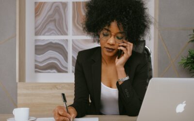 Lost government gateway - woman in suit jacket on the phone writing at a desk
