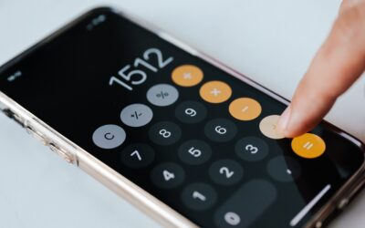 Calculate gross profit margins for e-commerce - finger on a calculator app on phone