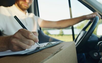 2021 VAT changes - man with arm on the wheel writing on a notepad on a delivery box